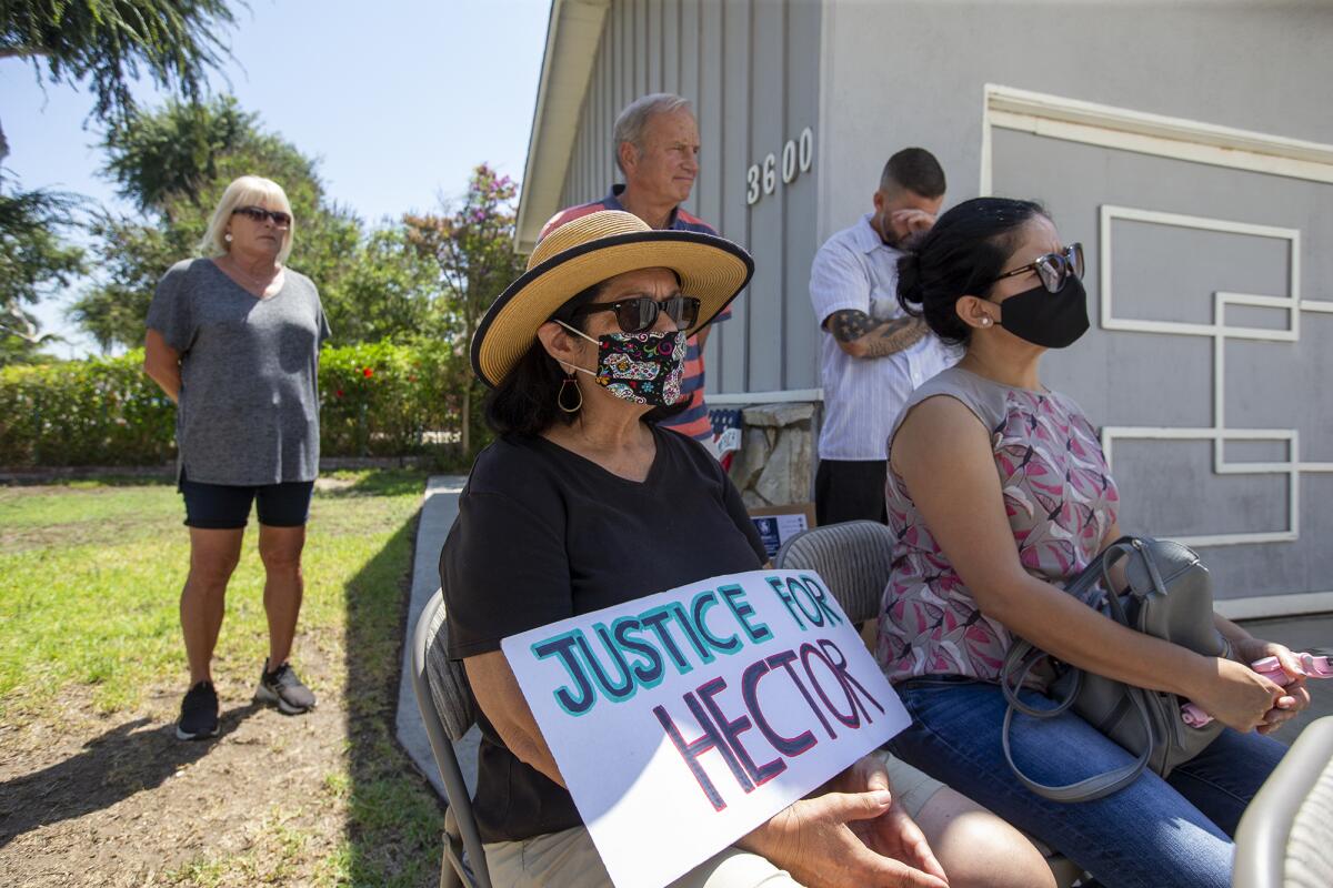 Susan Luevano holds a sign during a press conference concerning the killing of Hector Hernandez.