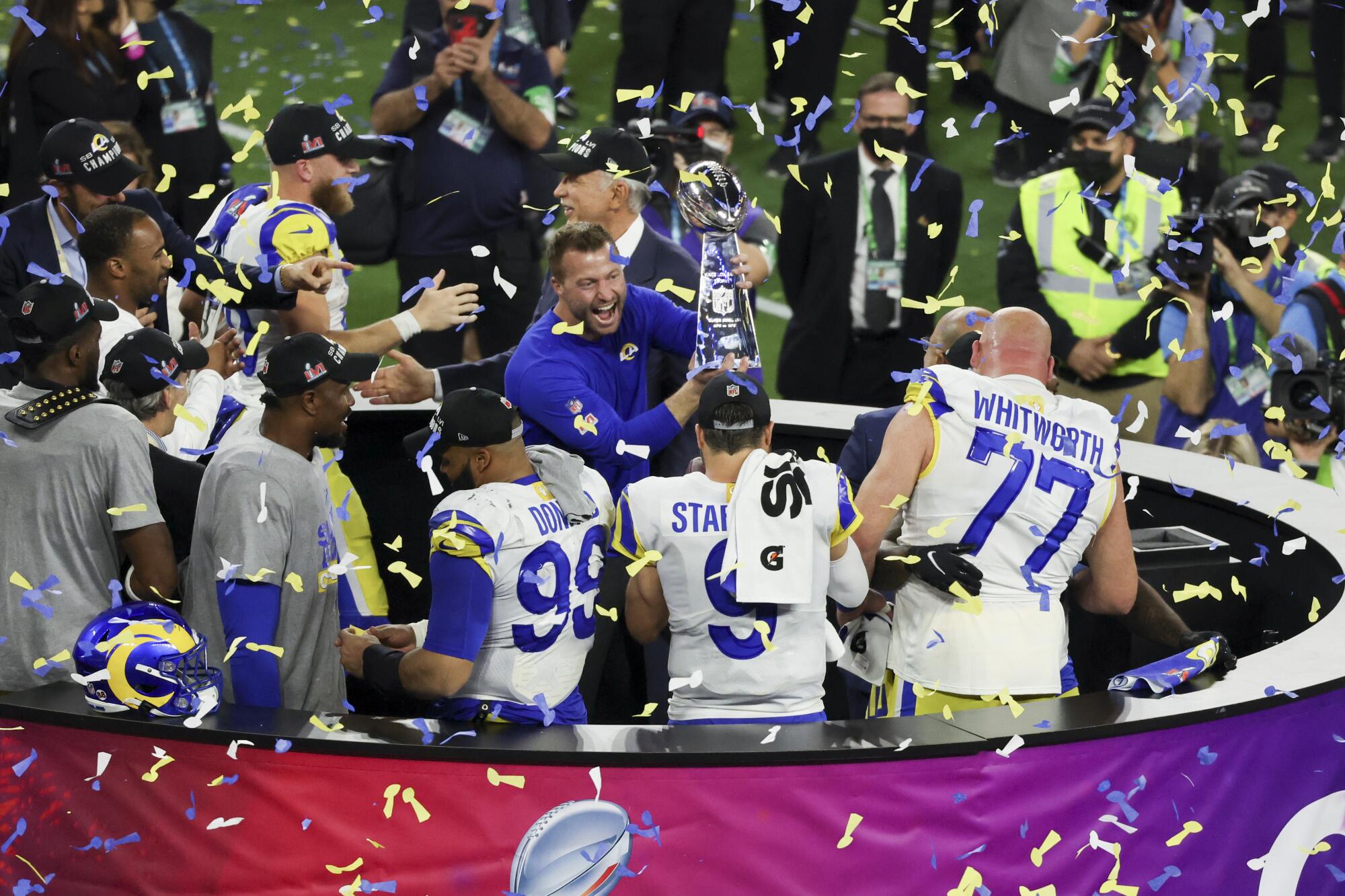 Coach Sean McVay holds the Lombardi Trophy after the Rams won Super Bowl LVI.