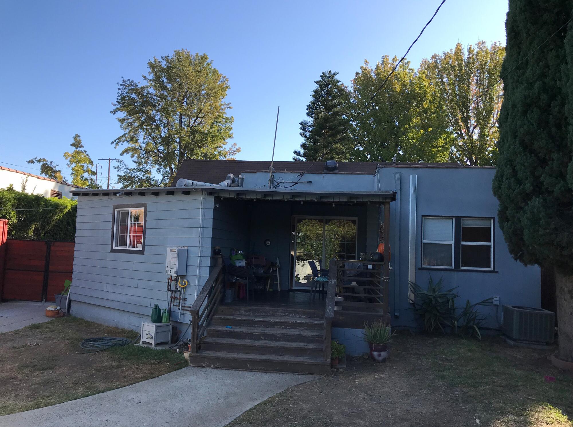 An old blue bungalow with stairs 