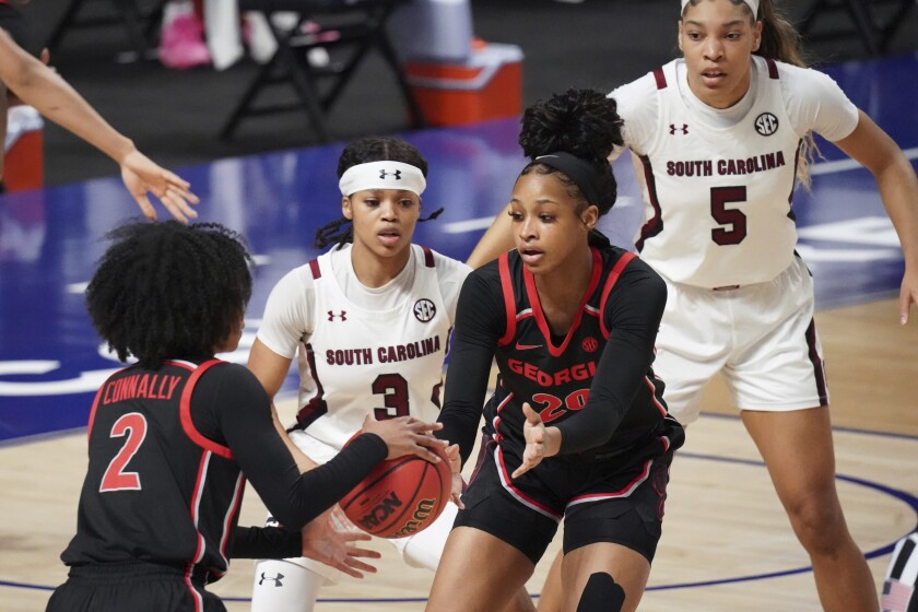 South Carolina guard Destanni Henderson (3) defends Georgia forward Jordan Isaacs (20) and Gabby Connally (2) during the first half of an NCAA college basketball game Sunday, March 7, 2021, during the Southeastern Conference tournament final in Greenville, S.C. (AP Photo/Sean Rayford)