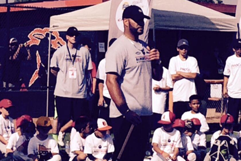 Angels first baseman Albert Pujols talks to kids at a baseball camp Sunday in Orange.