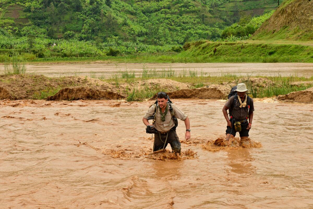 An image of Levison Wood crossing the Nyabarongo River, which cuts a swathe through Rwanda. From the book "Walking The Nile," by Levison Wood.