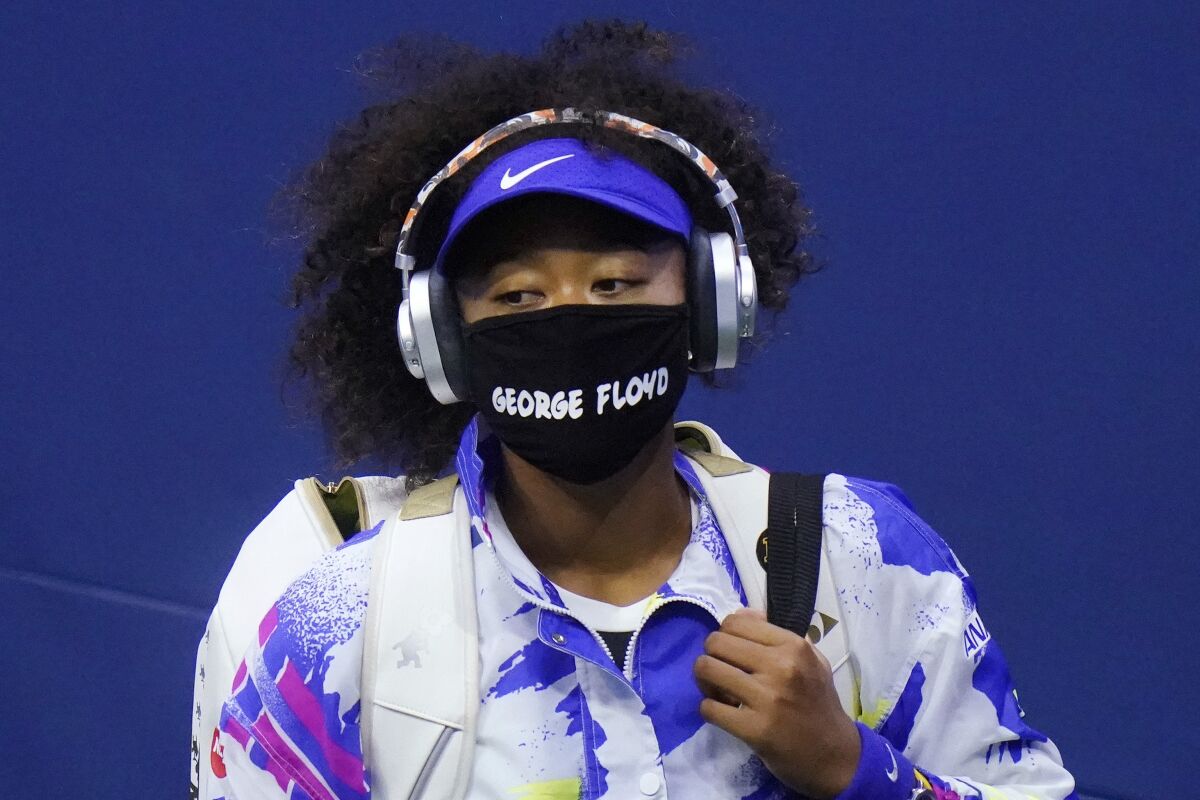 Tennis player Naomi Osaka wearing a mask that says "George Floyd"