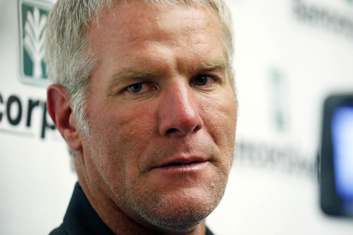 FILE - Former NFL quarterback Brett Favre speaks with reporters prior to his induction to the Mississippi Hall of Fame in Jackson, Miss., Saturday, Aug. 1, 2015. Mississippi's largest public corruption case in state history, in which tens of millions of dollars earmarked for needy families was misspent, involves a number of sports figures with ties to the state — including NFL royalty Brett Favre and a famous former pro wrestler. (AP Photo/Rogelio V. Solis, File)