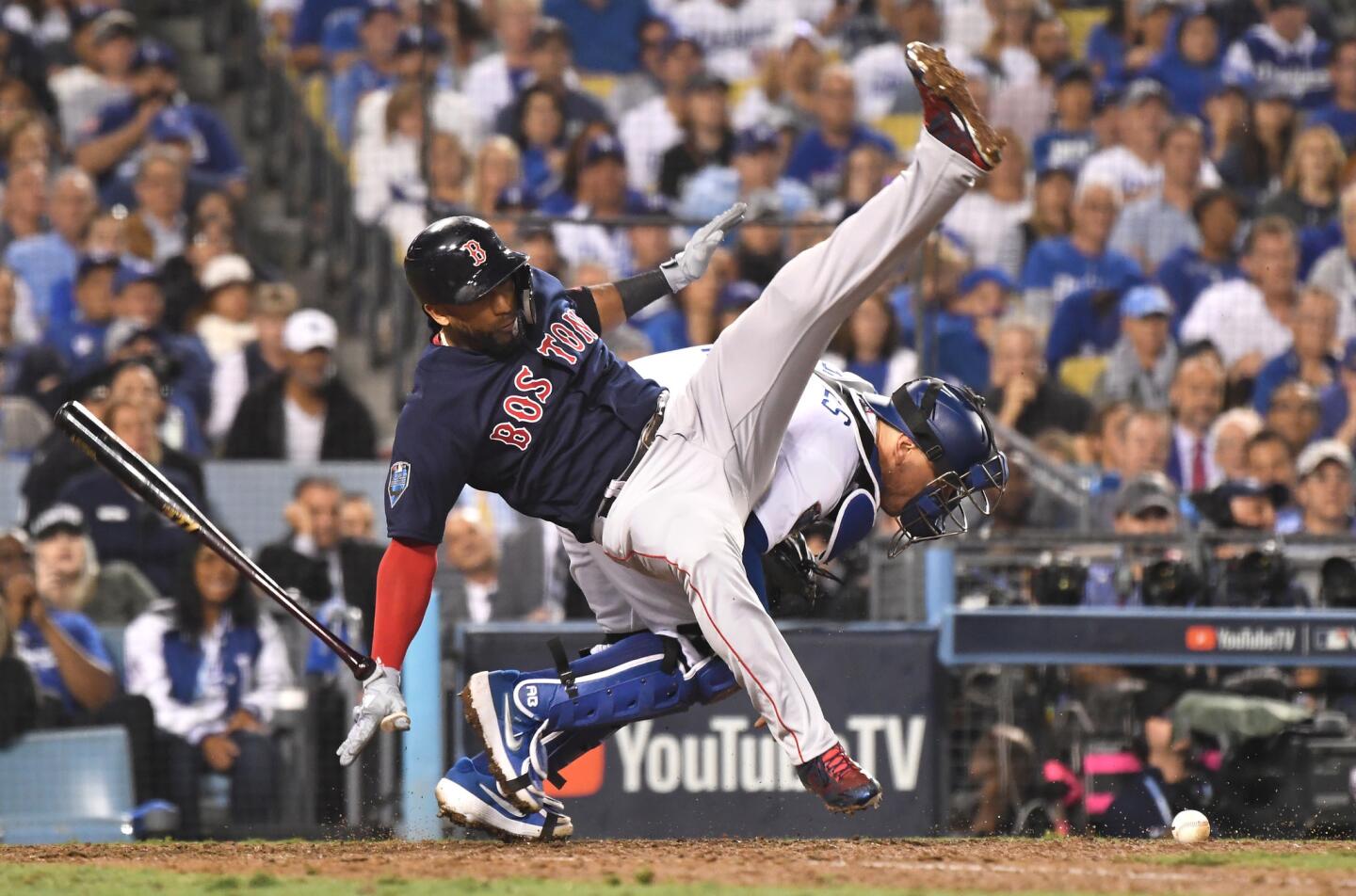 Red Sox batter Eduardo Nunez is upended by Dodgers catcher Austin Barnes in the 13th inning after a foul ball.