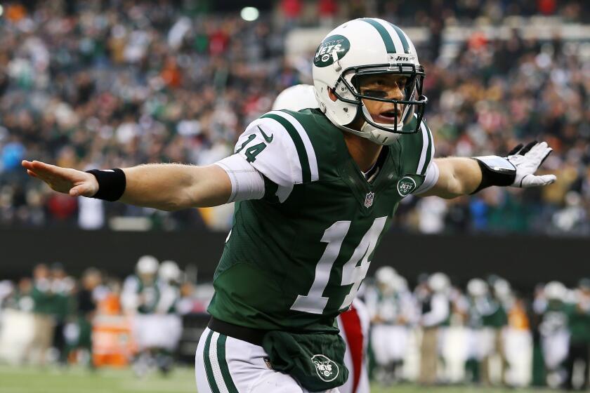 New York Jets quarterback Greg McElroy celebrates after throwing for his first NFL touchdown Sunday against the Arizona Cardinals.