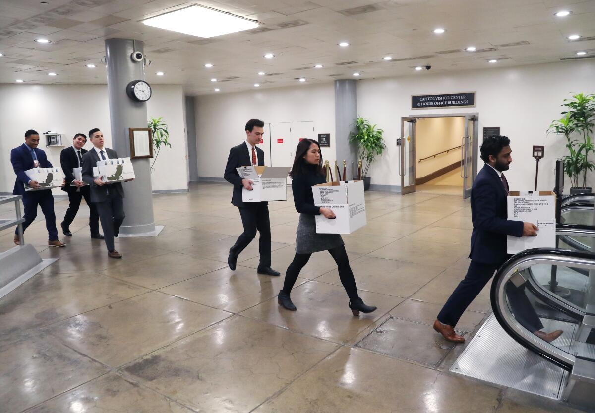 Senate staffers carry boxes to the Capitol.
