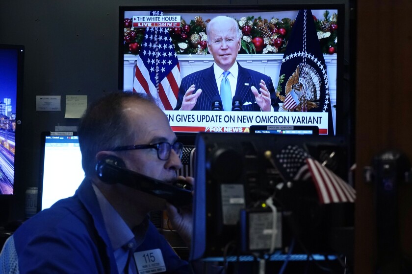 President Biden appears on a screen as traders work on the floor of the New York Stock Exchange on Nov. 29.