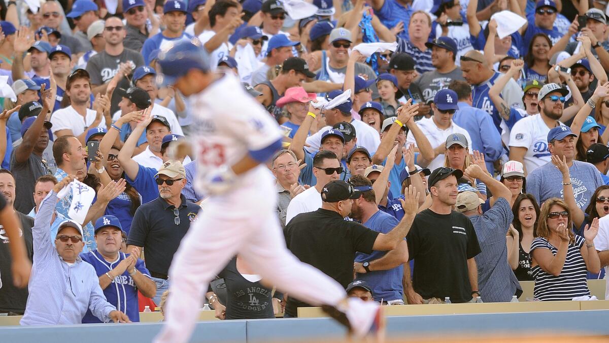 Dodgers fans celebrate a home run by first baseman Adrian Gonzalez during Game 3 of the 2013 National League Championship Series against the St. Louis Cardinals.