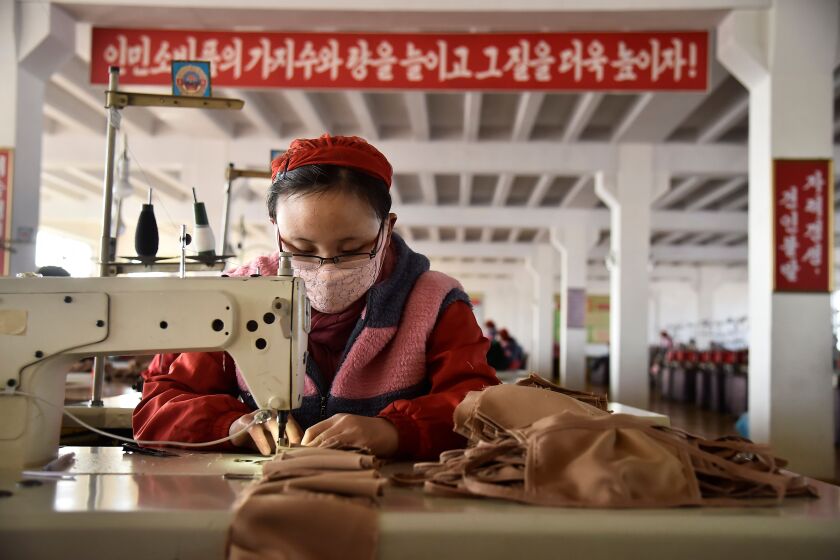 In this photo taken on February 6, 2020, a worker of the Songyo Knitwear Factory in Pyongyang produces masks for protection against the new coronavirus. - At least 31,000 people have been infected and more than 630 killed by the virus following the outbreak which began in the Chinese city of Wuhan, which has spread to two dozen countries. (Photo by Kim Won-Jin / AFP) (Photo by KIM WON-JIN/AFP via Getty Images)