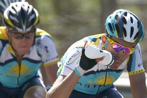 Alberto Contador takes a drink as he and Astana teammate Lance Armstrong race during Stage 15 of the Tour de France on Sunday. Contador would win the stage and claim the overall lead.