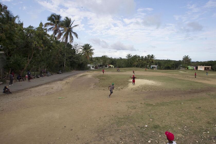 Just a few kilometers from the Padres training facility in the Dominican Republic, a roadside field hosts children playing.