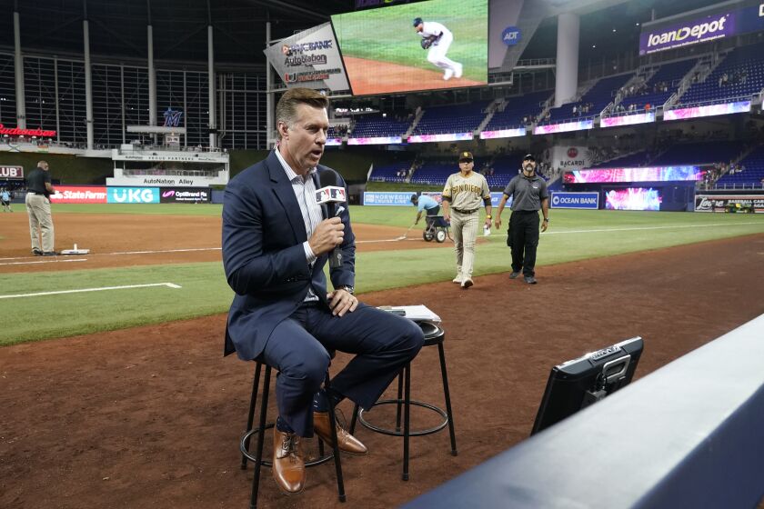 Bob Scanlan, field reporter for the San Diego Padres, goes on the air after a baseball game between the Miami Marlins and the Padres, Wednesday, May 31, 2023, in Miami. Major League Baseball took over broadcasts of the Padres' games Wednesday. (AP Photo/Wilfredo Lee)