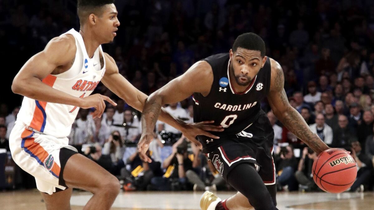 South Carolina guard Sindarius Thornwell (0), who finished with 26 points, tries to drive against Florida forward Devin Robinson during the first half Sunday.
