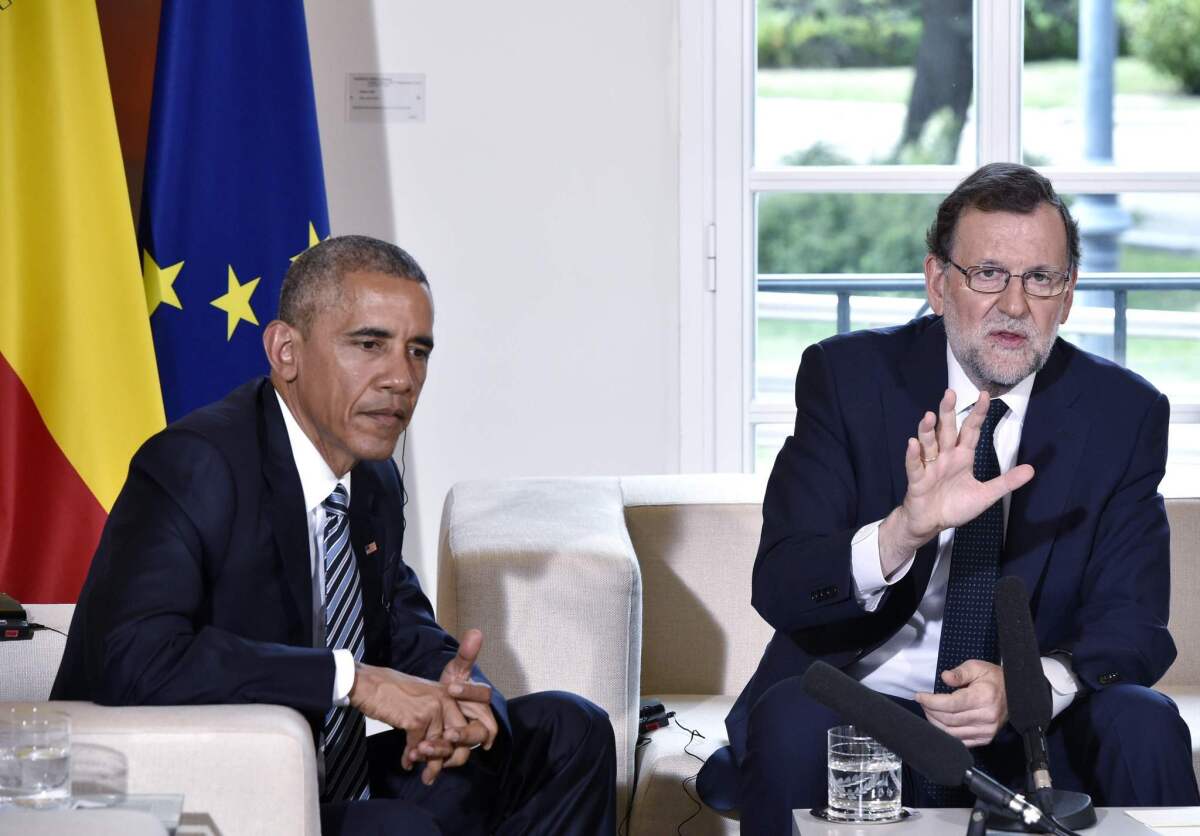 President Obama sits with Spain's interim prime minister, Mariano Rajoy, during a meeting in Madrid.