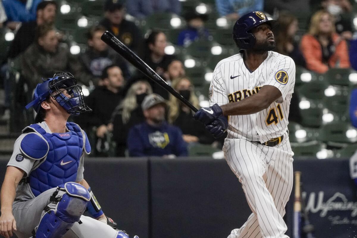The Brewers' Jackie Bradley Jr. hits a two-run homer against the Dodgers on April 30, 2021. Catcher Will Smith is at left.