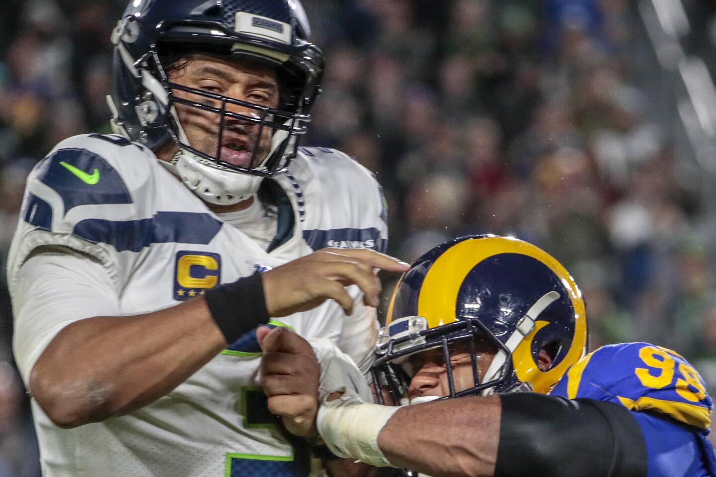 Rams defensive tackle Aaron Donald pressures Seattle Seahawks quarterback Russell Wilson.