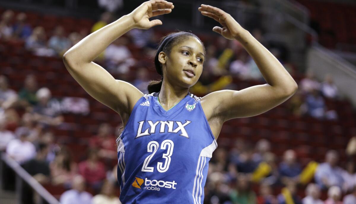 Maya Moore throws her arms overhead while reacting to an official's call during a Minnesota Lynx game in 2013.