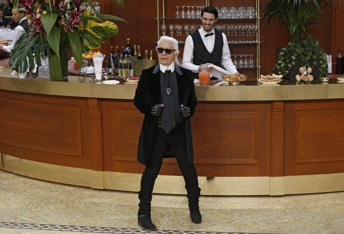 Designer Karl Lagerfeld at the finale of the fall 2015 Chanel ready-to-wear runway show during Paris Fashion Week. Chanel, a longtime e-commerce holdout, has announced plans to make some of its pieces available online by 2016.