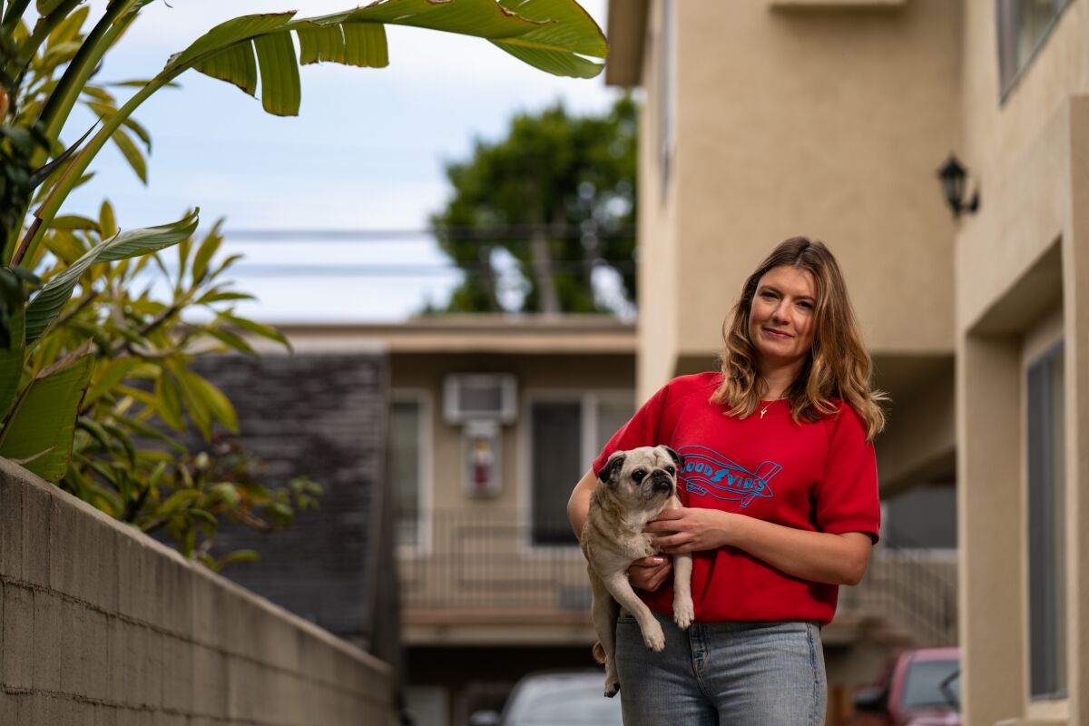 Kinga Basinska poses with her dog, Stella, outside of her apartment in the Palms neighborhood of Los Angeles. 