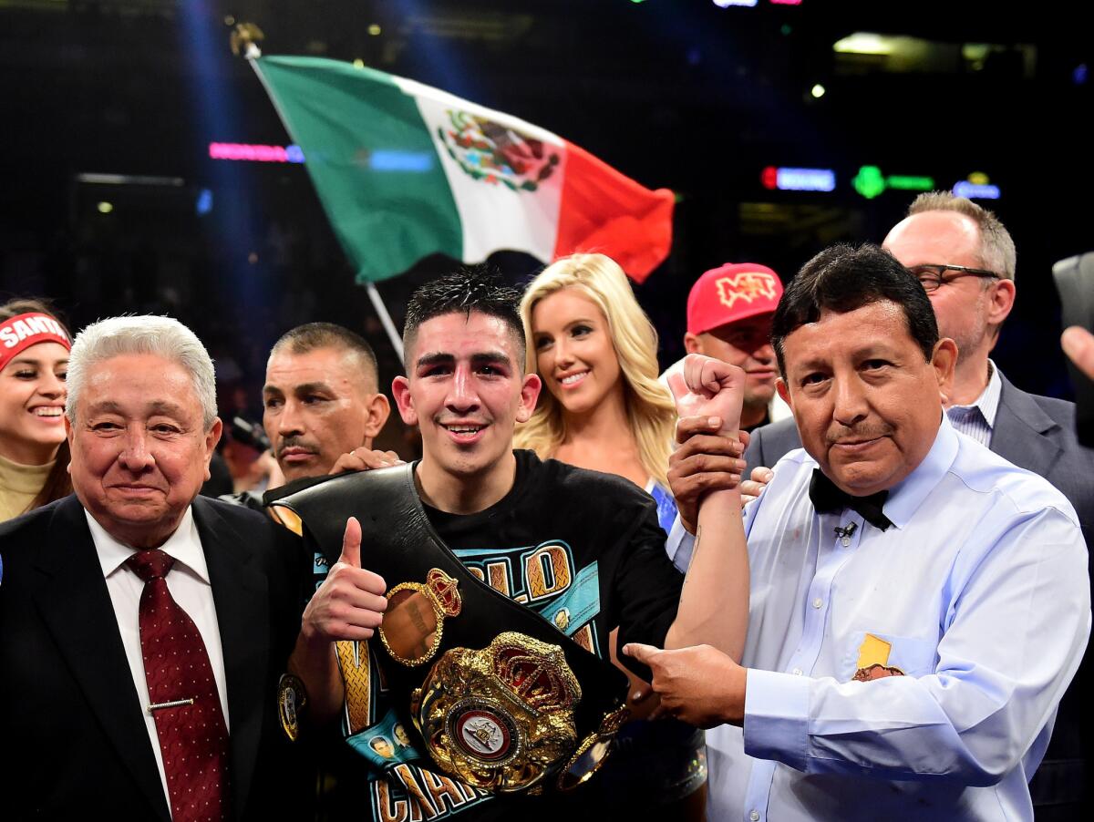 Leo Santa Cruz celebrates after a fifth-round TKO of Kiko Martinez at Honda Center on Feb. 27.