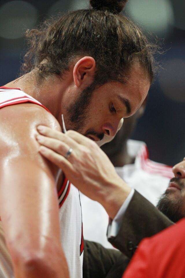 Joakim Noah gets assistance for a scratch near his left eyebrow after a scuffle with Paul Pierce in the first quarter.