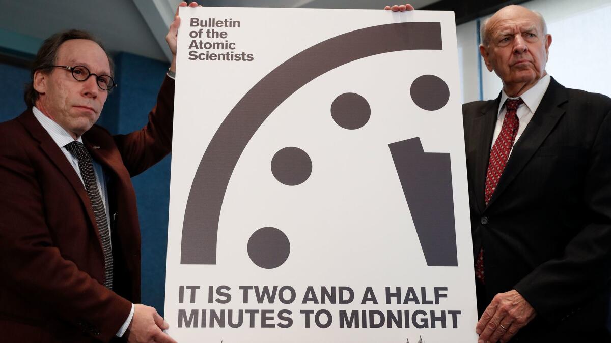 Lawrence Krauss, who is the author of this piece, and Thomas Pickering, co-chair of the International Crisis Group, display the Doomsday Clock during a news conference the at the National Press Club in Washington on Jan. 26.