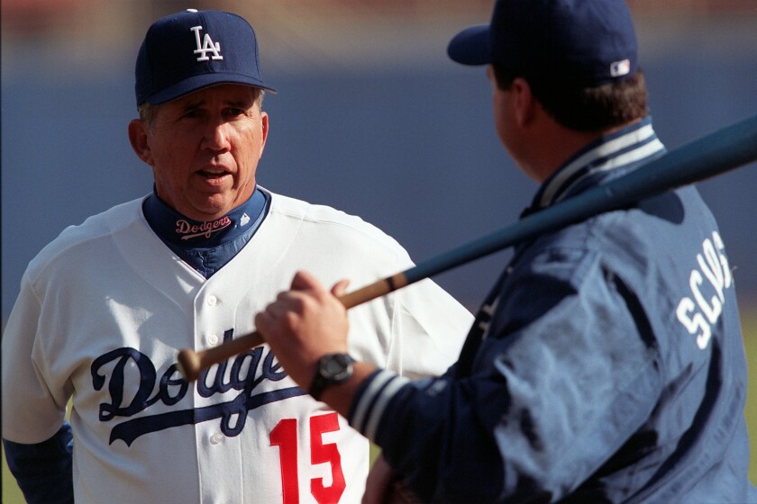 Dodgers manager Davey Johnson speaks with bench coach Mike Scioscia during spring training in 1999.