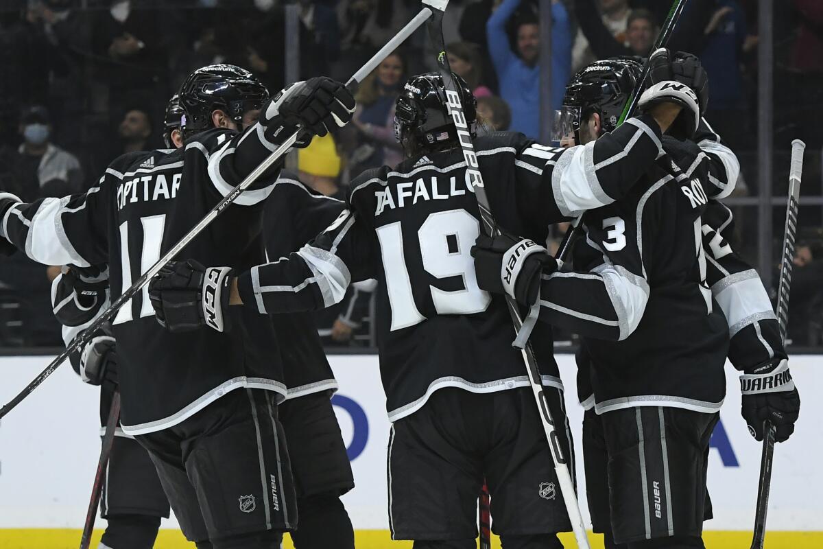 The Kings celebrate after right wing Alex Iafallo (19) scored in overtime against the New Jersey Devils