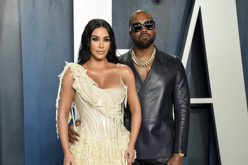 Kim Kardashian West, left, and Kanye West arrive at the Vanity Fair Oscar Party in Beverly Hills on Feb. 9, 2020.