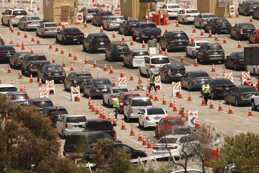 LOS ANGELES, CA - JULY 08: Testing continues Wednesday July 8, 2020 at Dodgers Stadium as drivers with an appointment continue in the queue for Coronavirus Covid-19 testing which has resumed at Dodger Stadium this week with a new drive-through testing. Dodger Stadium on Wednesday, July 8, 2020 in Los Angeles, CA. (Al Seib / Los Angeles Times)