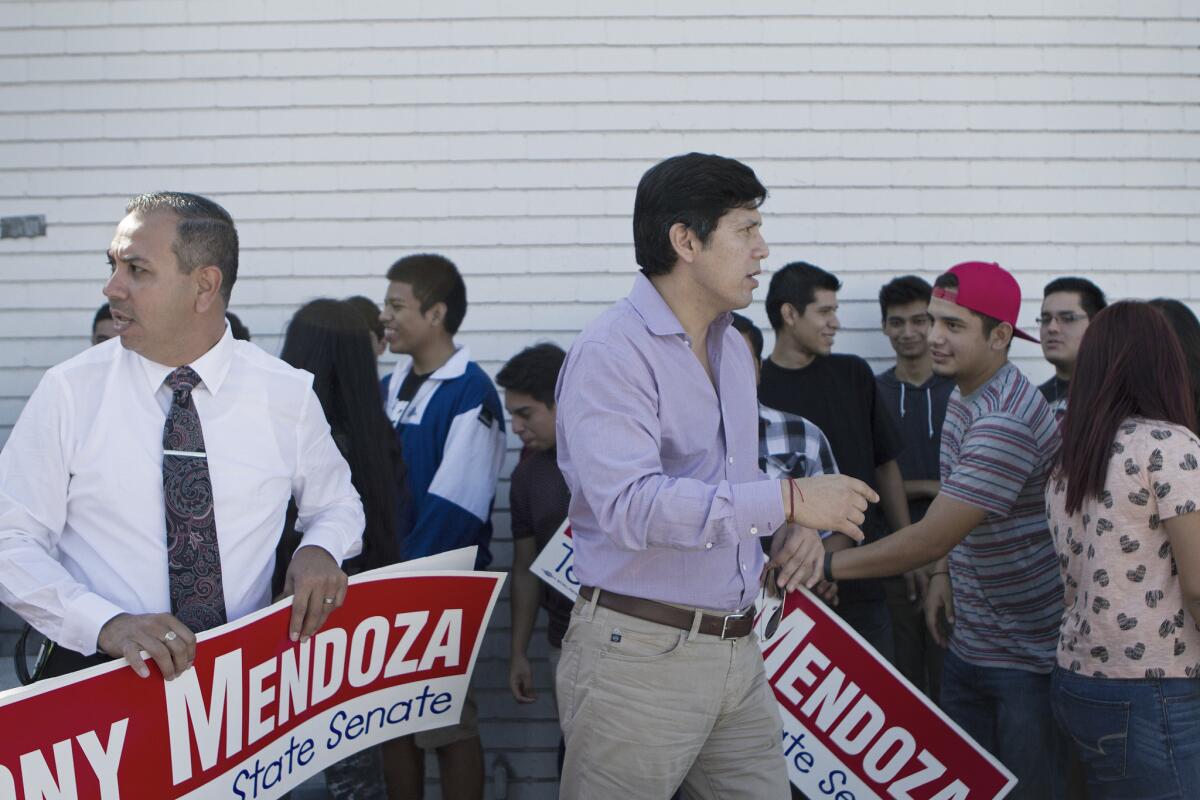 State Sen. Tony Mendoza (D-Artesia), left, is joined by state Sen. Kevin de Leon (D-Los Angeles) at a campaign rally last year. Mendoza is proposing a constitutional amendment that would expand the Board of Supervisors in Los Angeles County and other large counties in California from five to seven members.