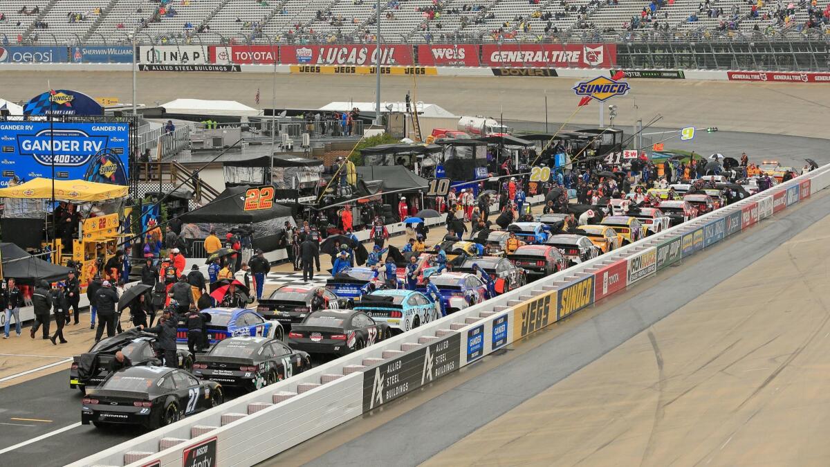 Cars are parked on pit road during a rain delay at Dover International Speedway on May 5.