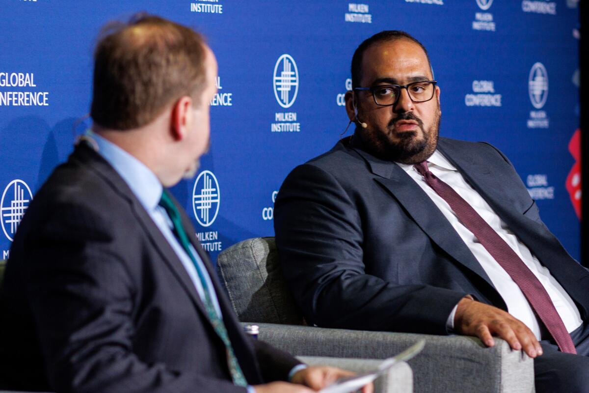 Faisal Alibrahim, Saudi Arabia's minister of economy and planning, right, with Kevin Klowden of the  Milken Institute.