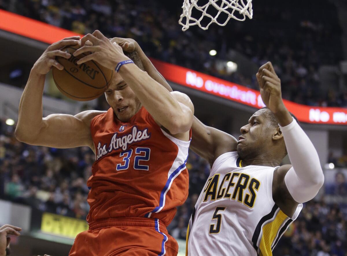 The Clippers' Blake Griffin grabs a rebound from Indiana's Lavoy Allen during a Dec. 10 in Indianapolis.