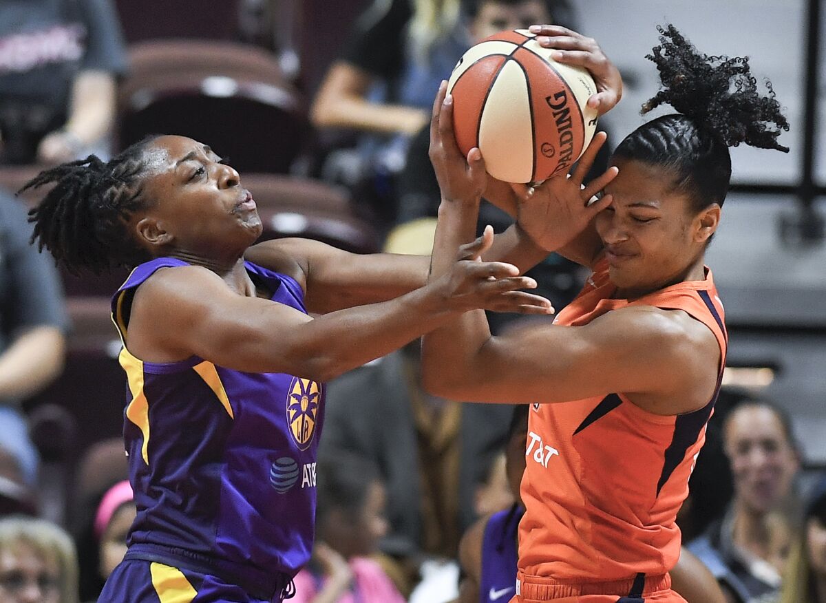 Sparks forward Nneka Ogwumike, left, and Connecticut forward Alyssa Thomas fight for a rebound.