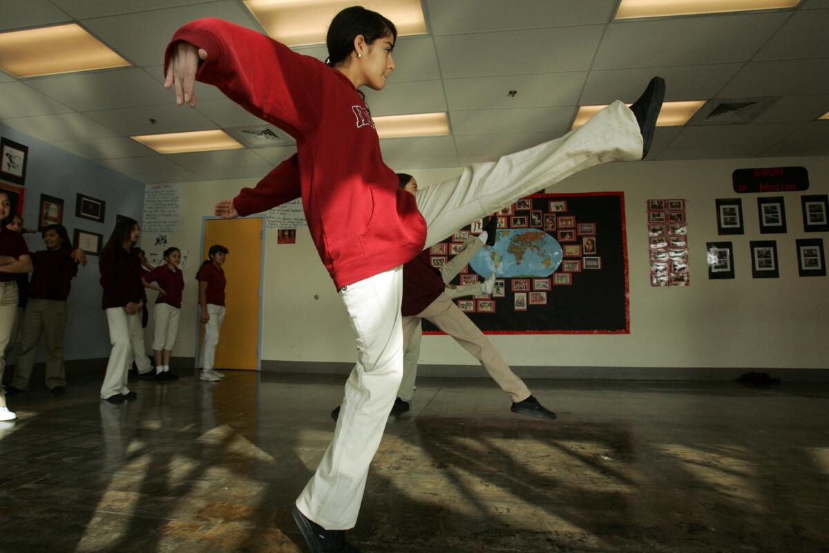 A student kicks up her heels in dance class at Aspire Public Schools in Huntington Park.