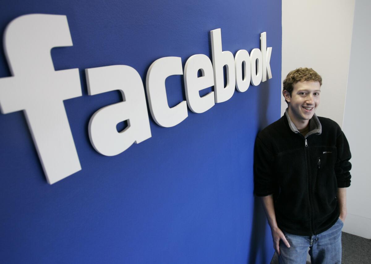 Facebook.com's mastermind, Mark Zuckerberg smiles at the company's office in Palo Alto on Monday, Feb. 5, 2007.