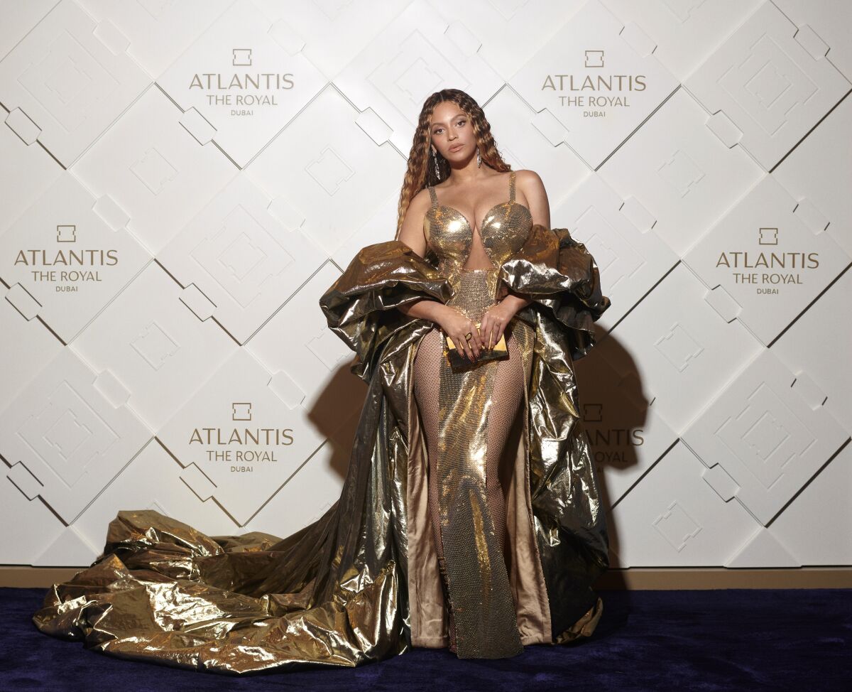 Beyoncé in a golden gown on a red carpet