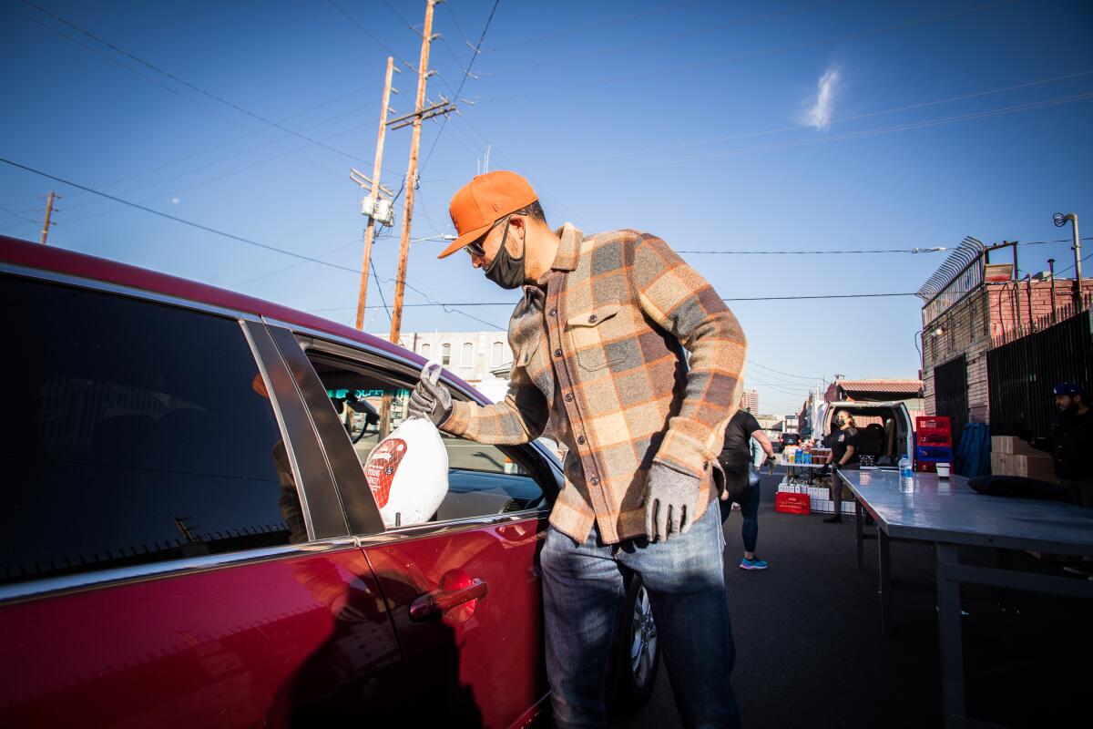 Former Dodgers outfielder Andre Ethier delivers a turkey through a car window.