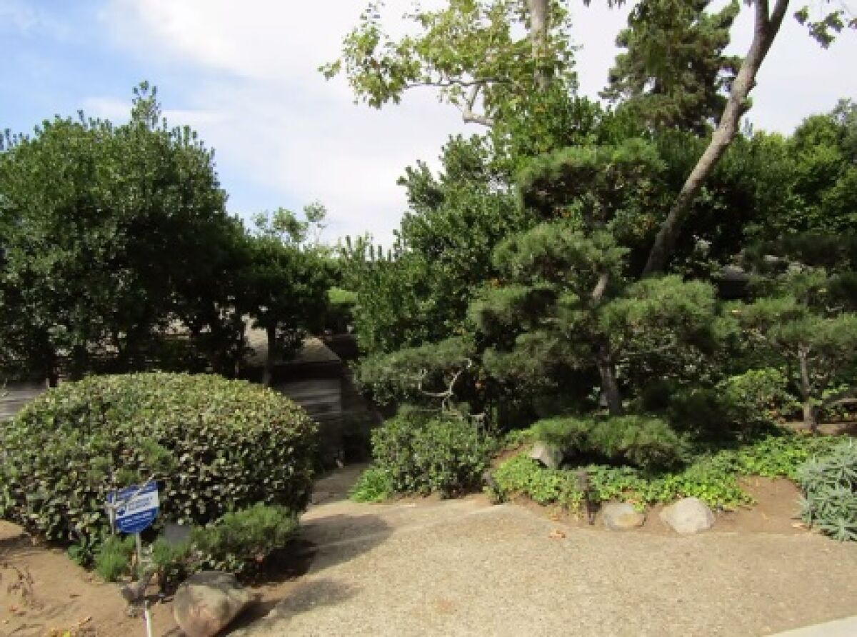 An image shows the landscaped frontage of the Joseph and Elizabeth Yamada House. 