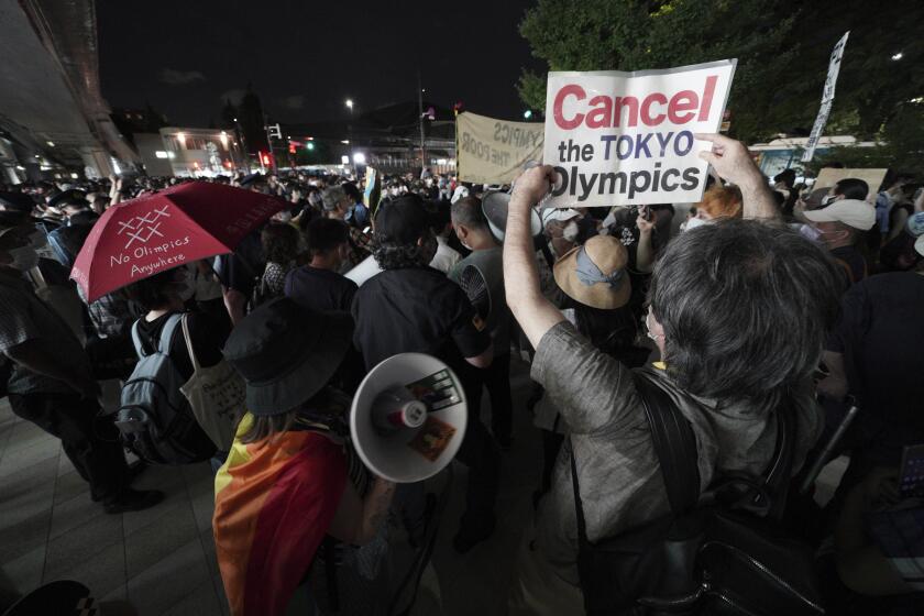 Anti-Olympic protestors demonstrate near the National Stadium in Tokyo, Japan where the opening ceremony of the Tokyo Olympics took place, Friday, July 23, 2021. (AP Photo/Kantaro Komiya)