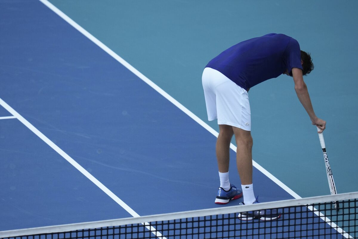 Daniil Medvedev of Russia leans over to rest between points, in his men's quarterfinal match against Hubert Hurkacz of Poland, at the Miami Open tennis tournament, Thursday, March 31, 2022, in Miami Gardens, Fla. (AP Photo/Rebecca Blackwell)