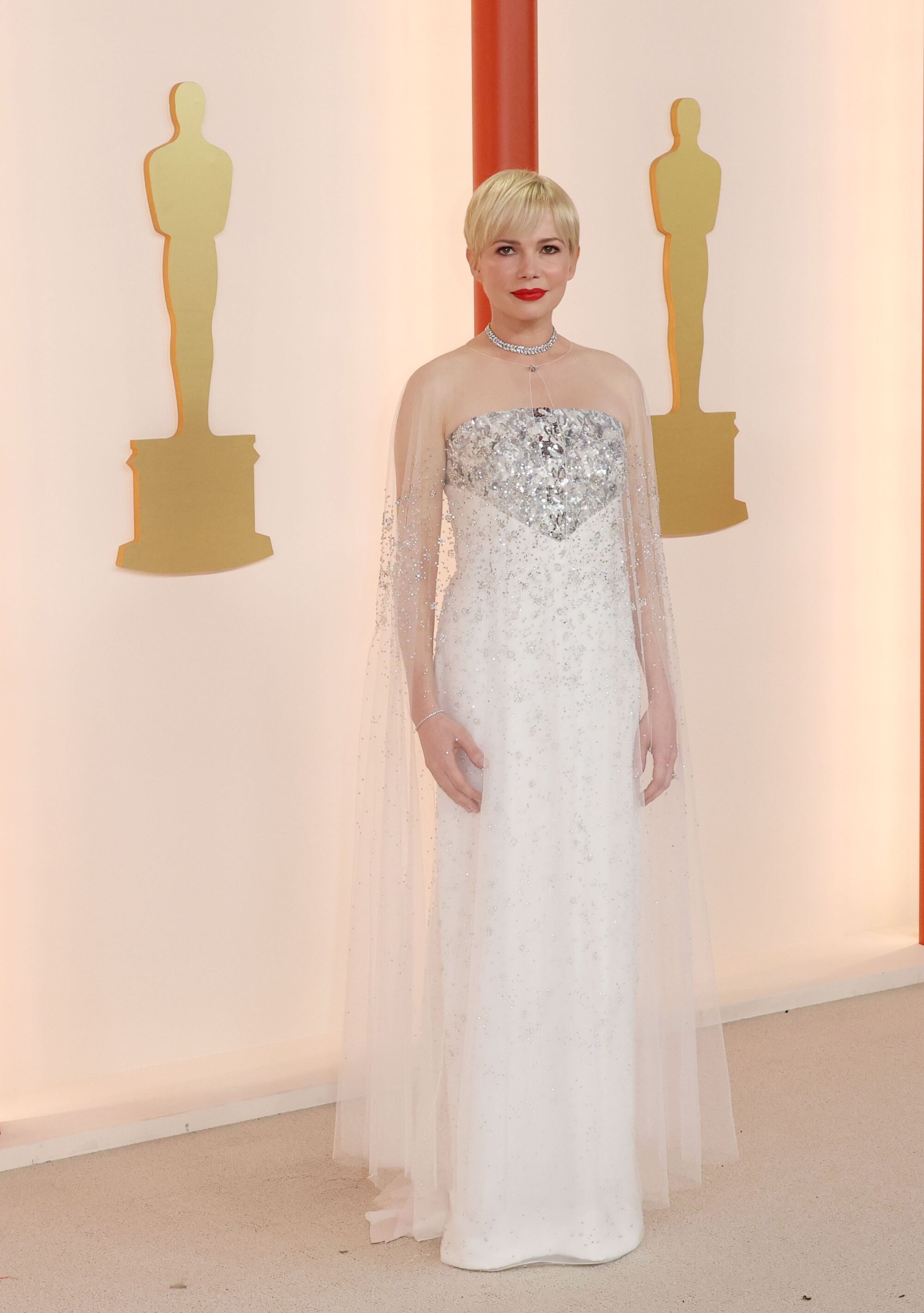 Michelle Williams in a gown with silvery, sparkling bustline and diaphanous white skirt. 