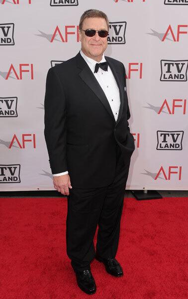 Here is Goodman posing at the AFI Life Achievement Award at the beginning of June 2010. He subtracted 100 pounds from his weight by August 2010.