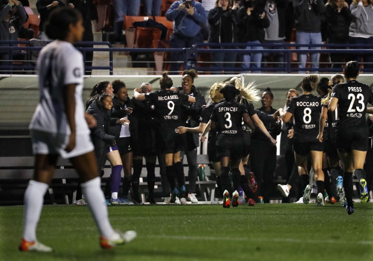 Angel City FC celebrates a goal by Savannah McCaskill