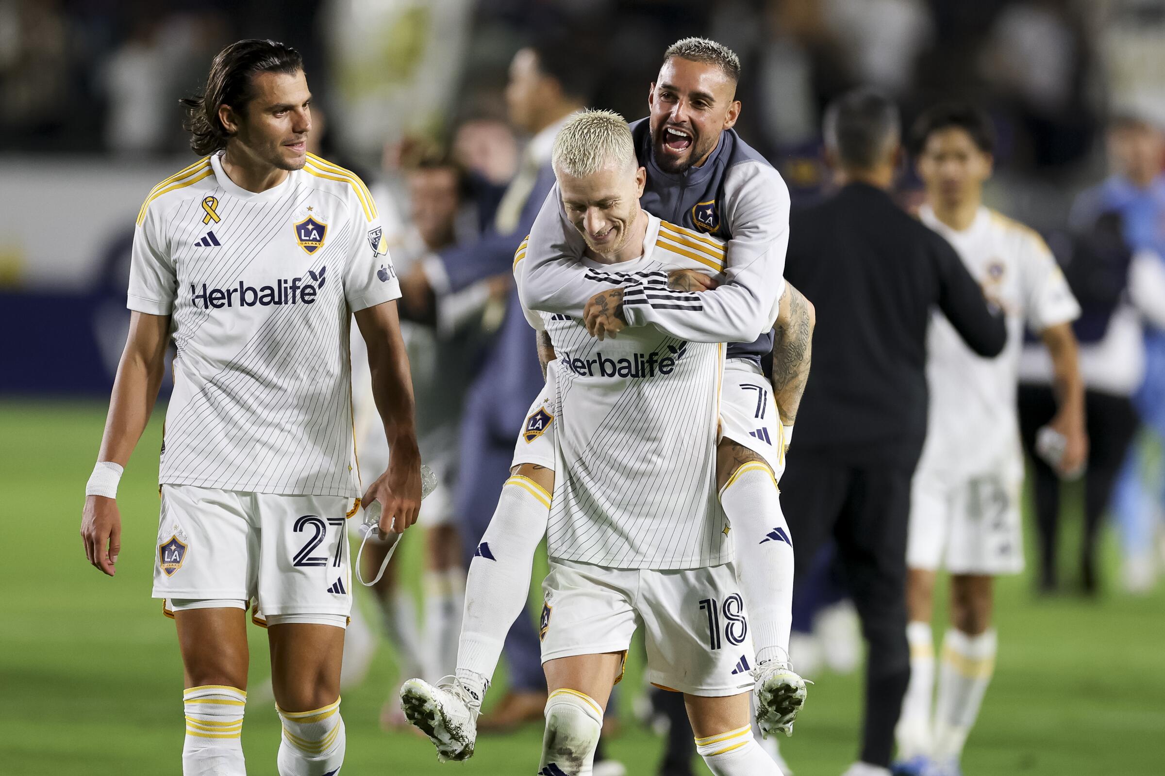 Galaxy forwards Marco Reus, center, and Diego Fagúndez, right, celebrate next to Miguel Berry after the team's win over LAFC.