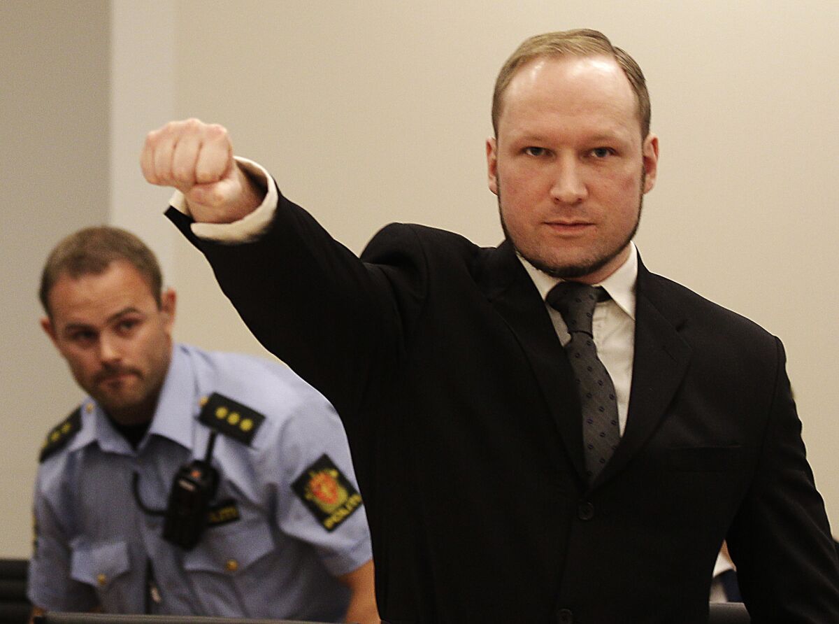 In this Aug. 24, 2012, photo, mass murderer Anders Behring Breivik gives a salute after arriving in a courtroom in Oslo.