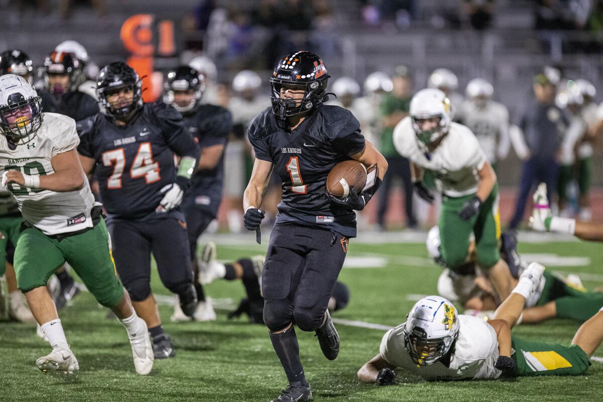 Los Amigos' Bao Huynh runs up field during a Garden Grove League football game against Rancho Alamitos on Thursday.