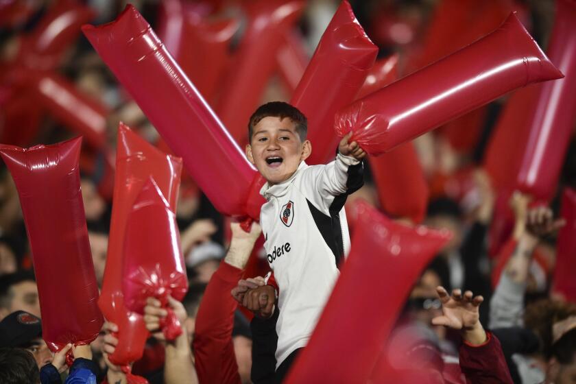 ARCHIVO - En esta foto del martes 24 de septiembre de 2024, un niño alienta a River Plate en un partido de cuartos de final de la Copa Libertadores ante Colo Colo, en el Estadio Monumental de Buenos Aires (AP Foto/Gustavo Garello)